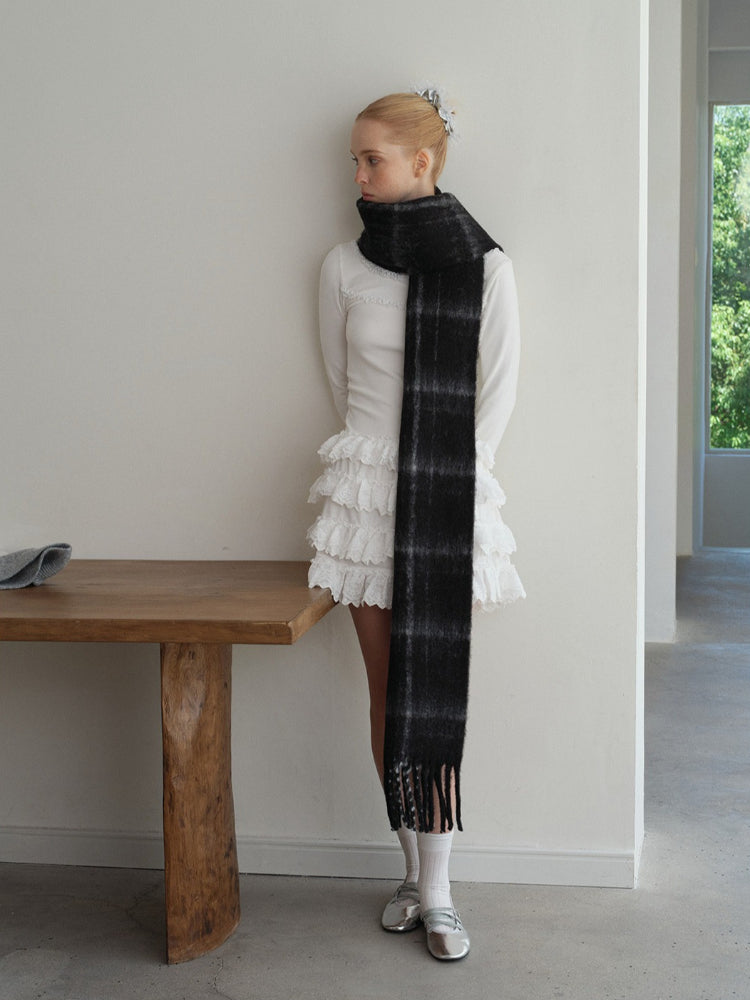 Model facing left, wearing a long, black and grey plaid scarf. Secondary image
