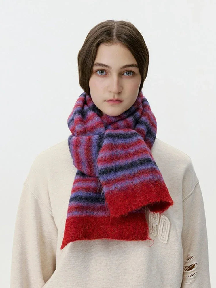 Woman wearing a red and purple striped fuzzy scarf