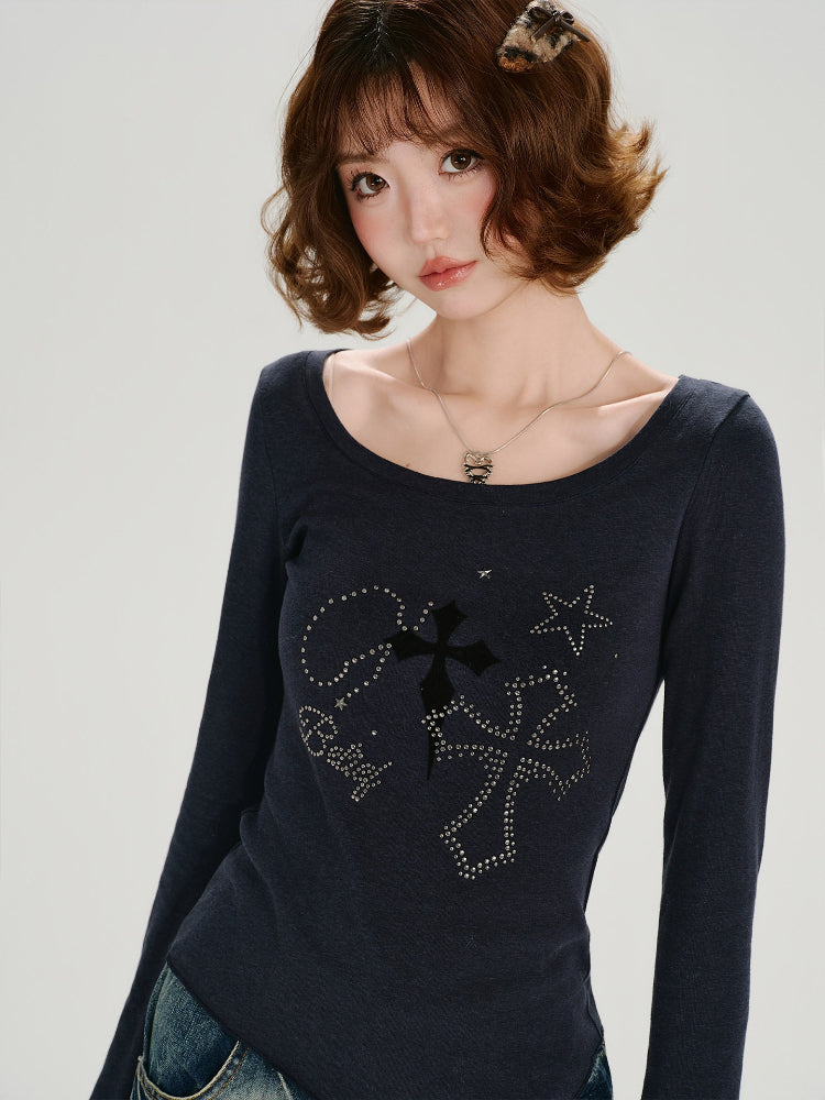 Model posing with a dark blue long-sleeve top featuring a graphic print and embellishments.