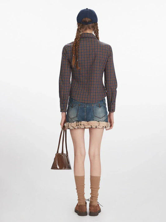 Full-body back view of a woman wearing a plaid button-down shirt, denim mini skirt with faux fur trim, and a tie.