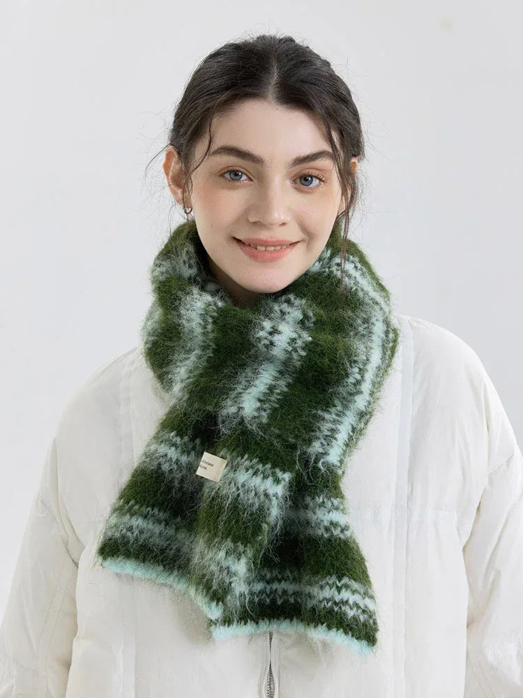 Close-up of a model wearing a green and blue striped scarf.