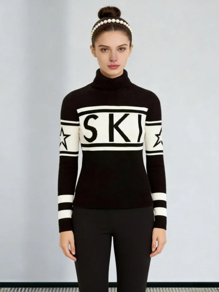 Woman wearing a black and white turtleneck ski sweater with the word "SKI" printed across the chest and stars on the sleeves. Main image