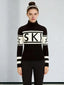 Woman wearing a black and white turtleneck ski sweater with the word "SKI" printed across the chest and stars on the sleeves.