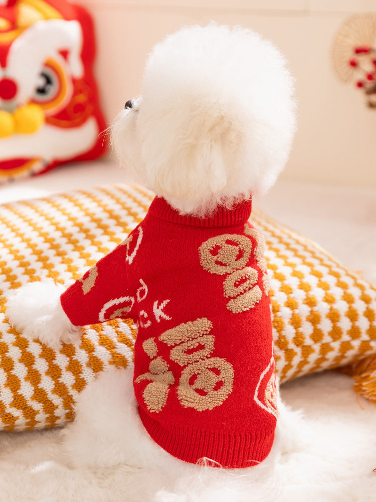 Rear view of a white Bichon Frise dog in a red knit sweater with gold embroidered Chinese characters.
