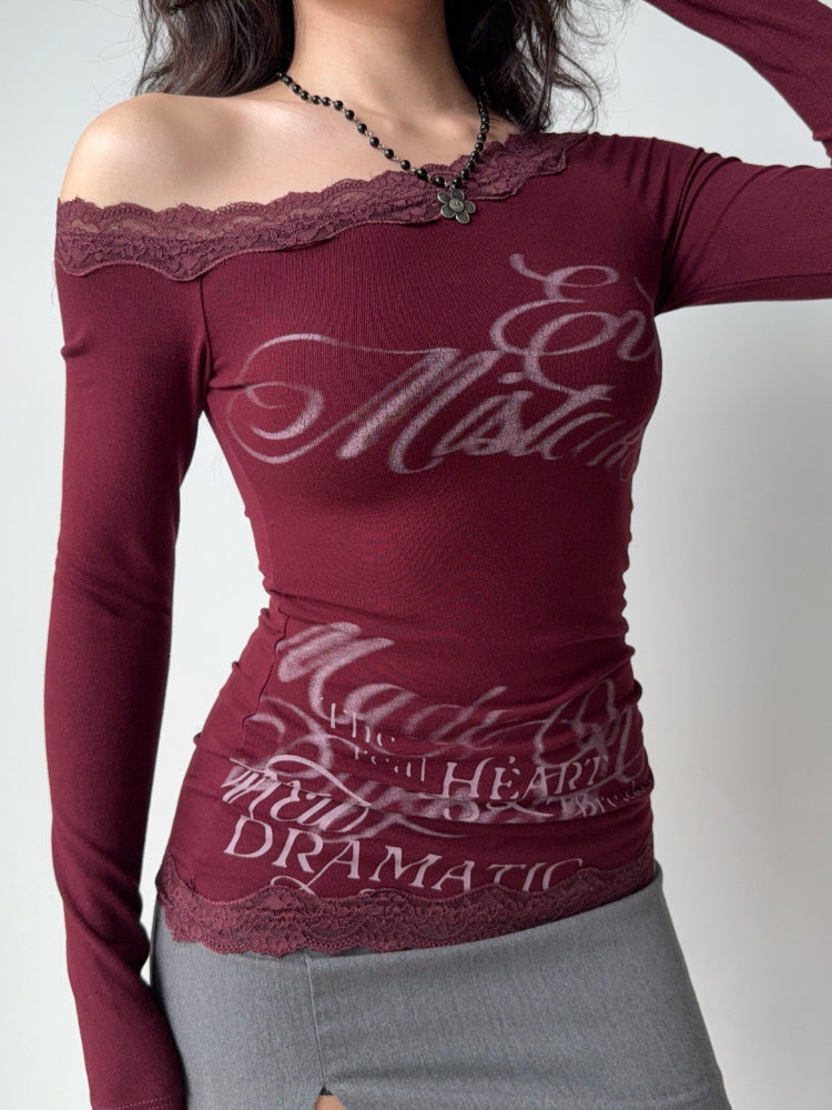 Close-up of the burgundy top showing the lace trim and graphic print.