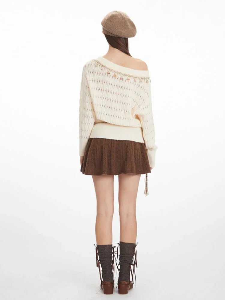 Back view of a woman wearing a cream-colored off-the-shoulder knit sweater with a brown A-line skirt. Secondary image