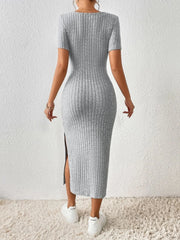 Back view of a woman wearing a grey ribbed knit midi dress with short sleeves and a square neckline.