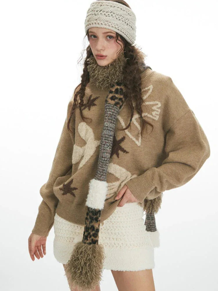 Medium shot of a woman wearing a brown sweater with a bird and star pattern, a white textured skirt, and accessories, posing with hands near her head.