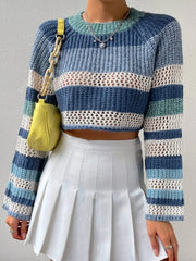 Woman wearing a blue and white striped crochet knit cropped sweater with bell sleeves, paired with a white pleated mini skirt and a yellow handbag.