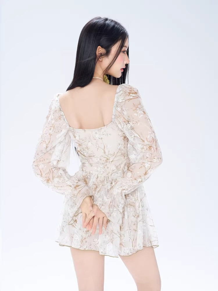 Back view of a woman in a floral print dress, showcasing the square back and long sleeves.
