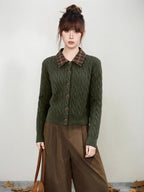 Front view of a woman in a green cable knit cardigan