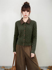 Front view of a woman in a green cable knit cardigan