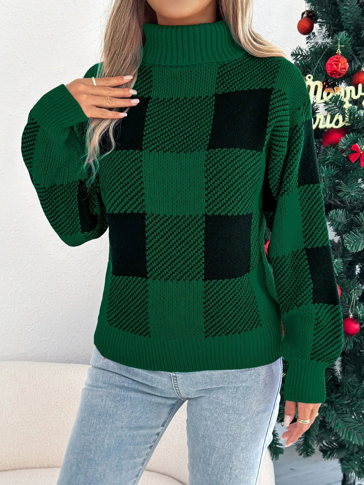 Woman in a green and black buffalo plaid turtleneck sweater posing with hand on hip