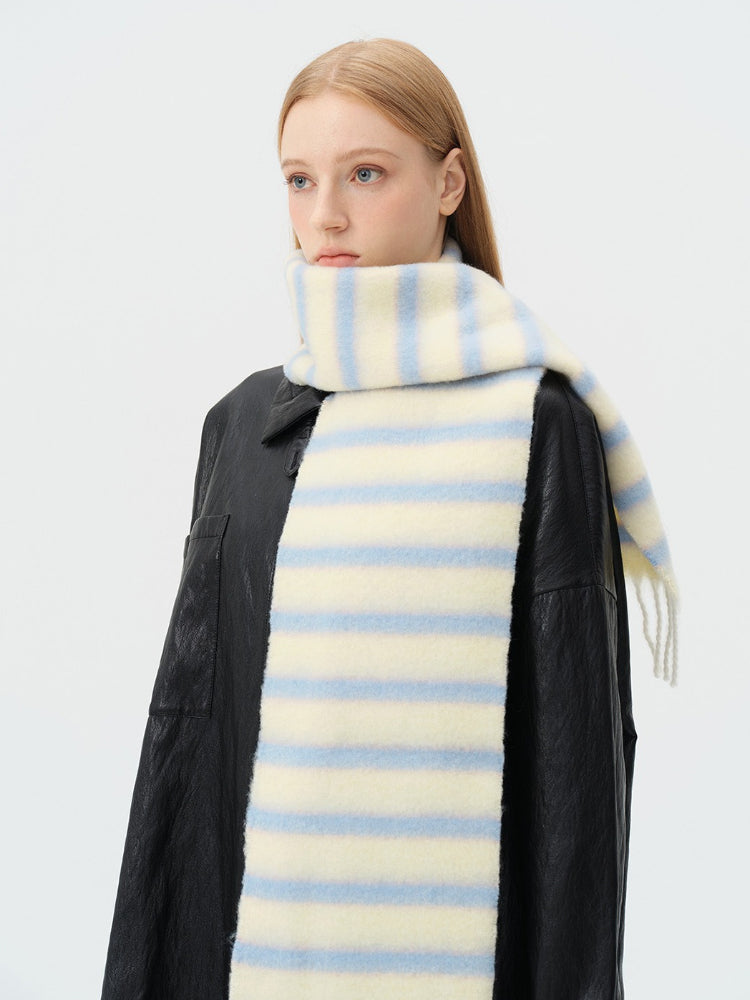 close-up of a model wearing a light yellow and blue striped scarf