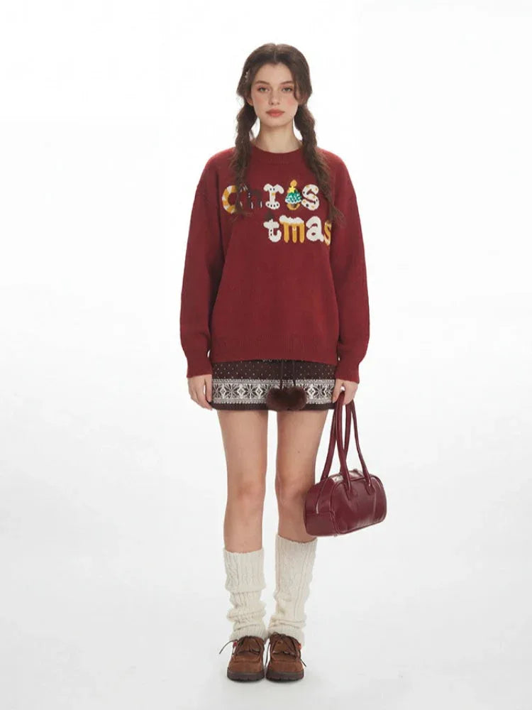 Woman wearing a burgundy Christmas sweater with "Christmas" graphic, patterned shorts, and leg warmers, holding a burgundy handbag. Main image