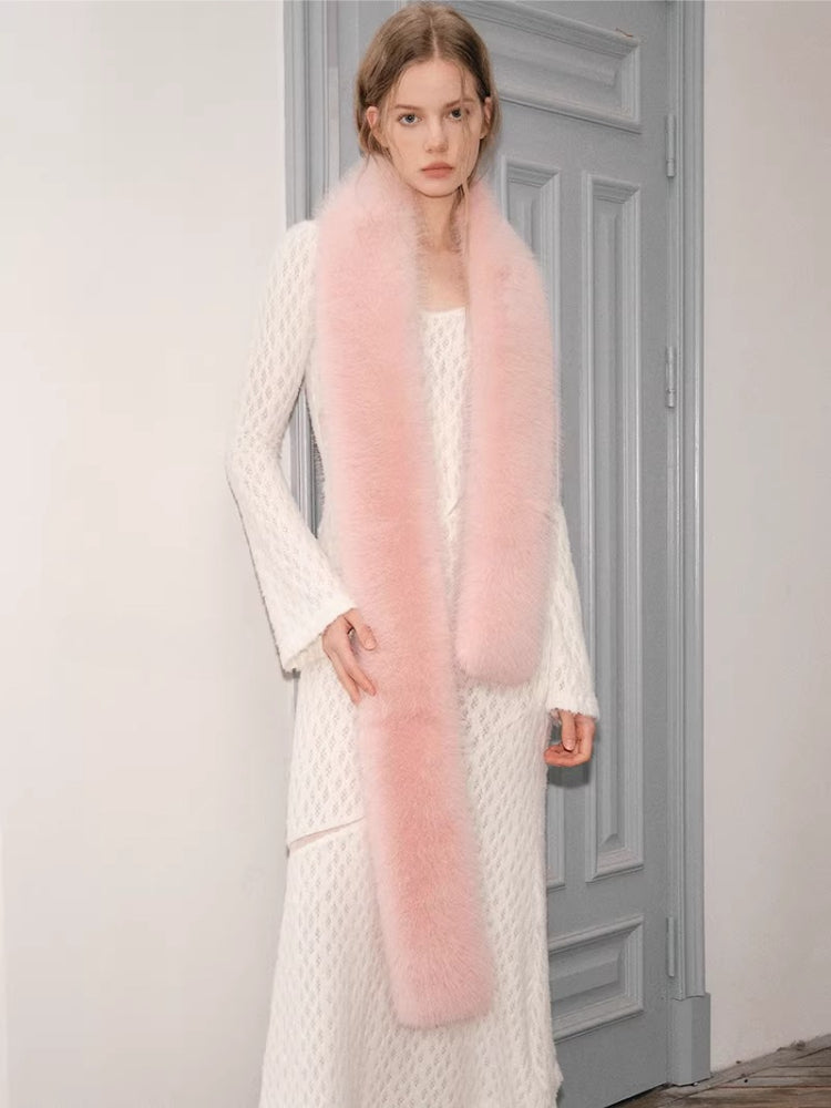 model in a white textured dress with a long pink scarf