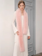 model in a white textured dress with a long pink scarf