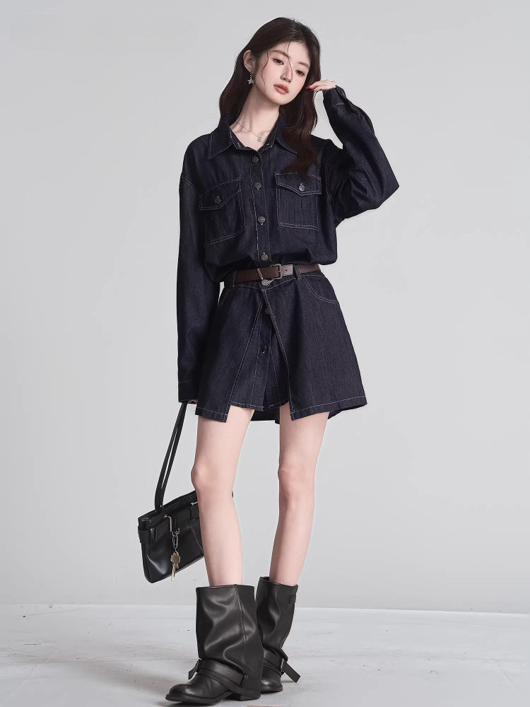 Woman in a dark wash denim shirt dress with a brown belt, holding a black handbag and wearing black boots.