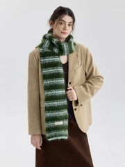 Model wearing a tan blazer and a brown skirt with a green and blue striped scarf.