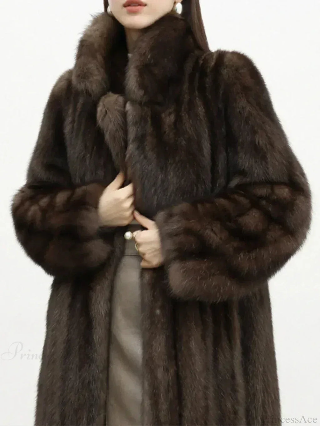 Close-up of a woman wearing a brown mink fur coat, showing the fur texture and lapel collar.