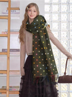 Close-up of a woman wearing a multicolored polka dot scarf.