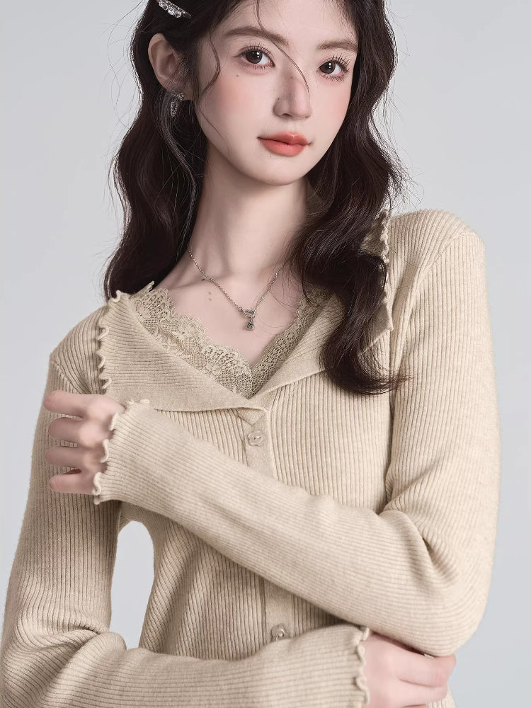 Close-up of a woman wearing a beige ribbed knit cardigan with lace trim and a V-neck.