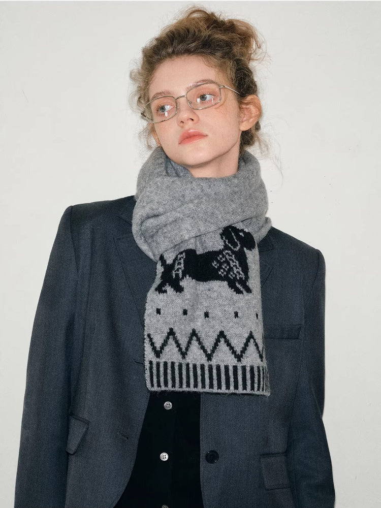 Full body shot of a model in a gray suit and a dachshund-patterned scarf.