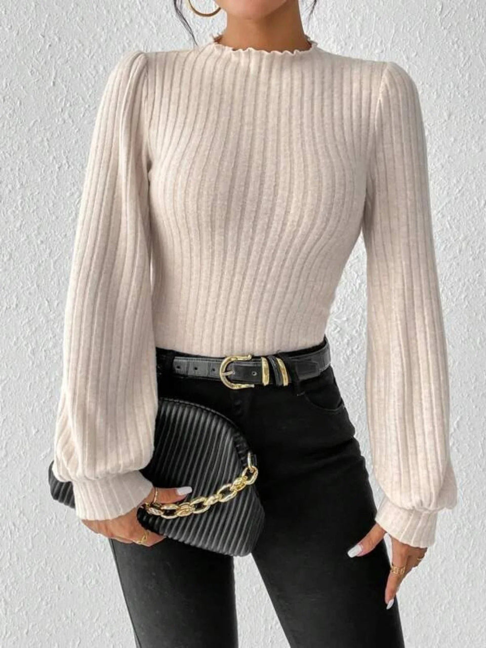 Woman in a cream-colored ribbed knit bodysuit with puff sleeves, holding a black clutch with a gold chain. Secondary image