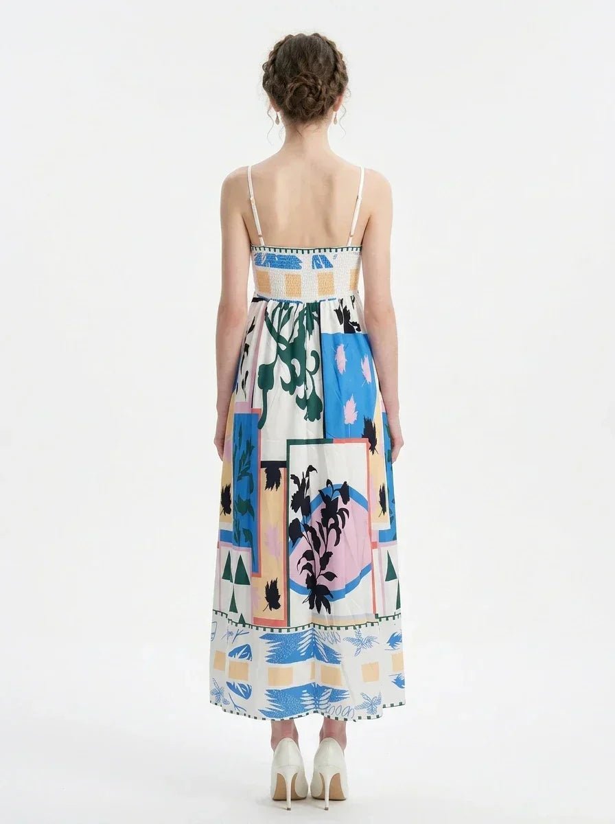 Full back view of a woman wearing a midi dress with an abstract geometric print and spaghetti straps.