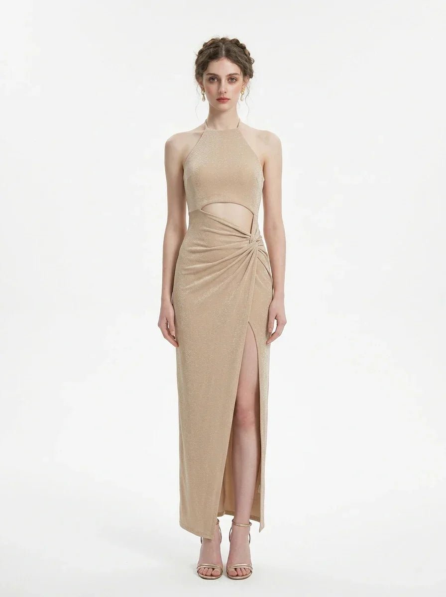 A woman models a shimmering champagne halter neck maxi dress with a cut-out and high slit.