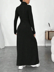 Back view of a woman wearing a black ribbed knit maxi dress with a turtleneck and long sleeves.