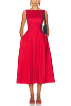 Model wearing a red sleeveless midi dress with a boat neck and full skirt.