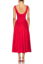 Back view of a model in a red sleeveless midi dress with a boat neck and full skirt.