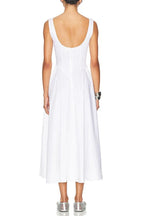 Back view of a model in a white sleeveless midi dress with a boat neck and full skirt.