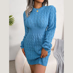 Front view of a woman in a blue cable knit dress with a crew neck and long sleeves.