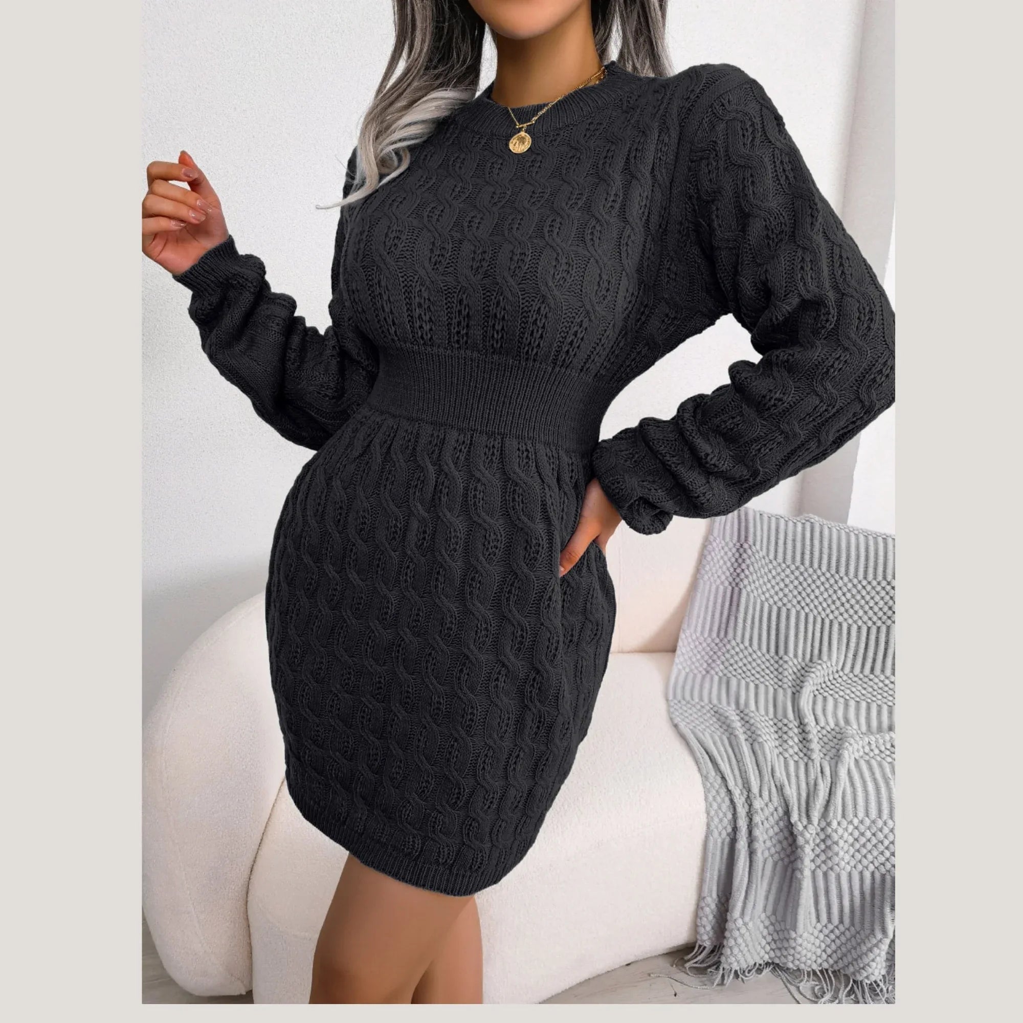 Front view of a woman in a black long-sleeved knit dress.