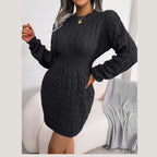 Front view of a woman in a black long-sleeved knit dress.