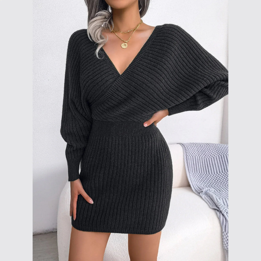 Full body shot of a woman in a charcoal ribbed knit dress.