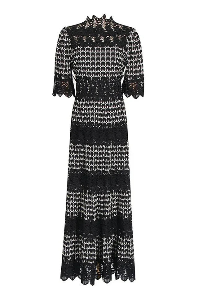 Full-length view of a black and white geometric print midi dress with lace details