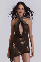 Model wearing a distressed knit halter mini dress with an open cutout and asymmetrical hem