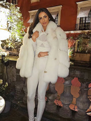 woman wearing a white faux fur coat with a white top and white pants