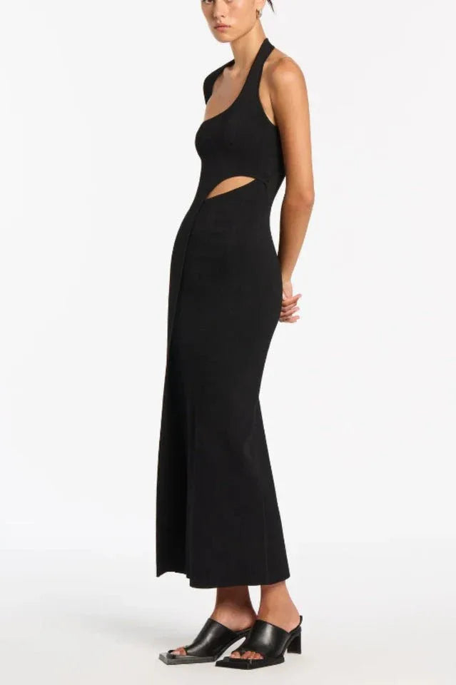Side view of black one-shoulder ribbed knit maxi dress with cut-out and high slit