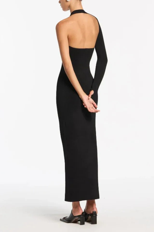 Back view of black one-shoulder ribbed knit maxi dress with cut-out and high slit