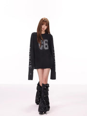 Full body shot of a model wearing a black long sleeve top and black boots.