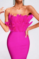 Close-up of the feather trim on the bodice of a hot pink strapless midi dress.