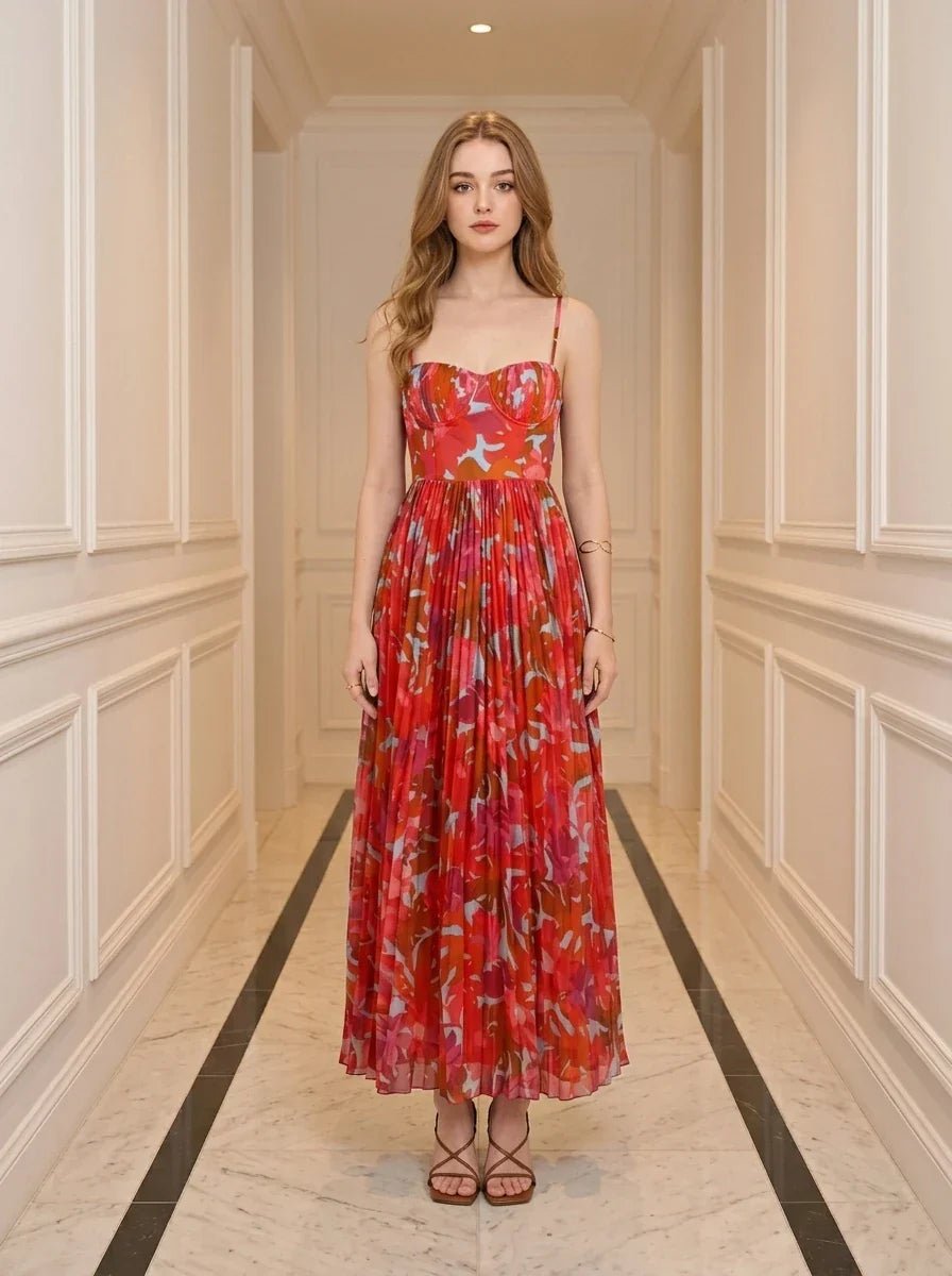 Woman standing in a hallway wearing a red floral print maxi dress with spaghetti straps and a sweetheart neckline.