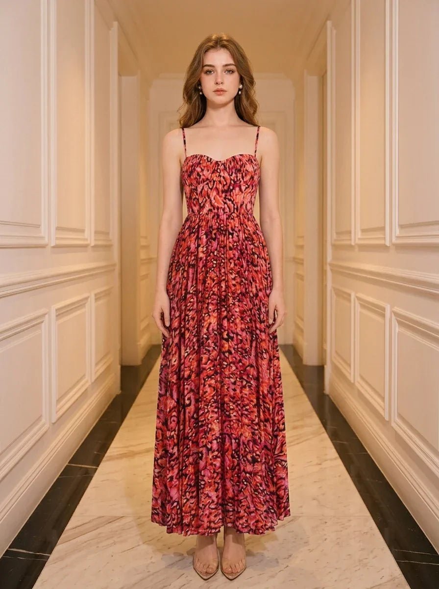 Woman in a red floral print maxi dress standing in a hallway