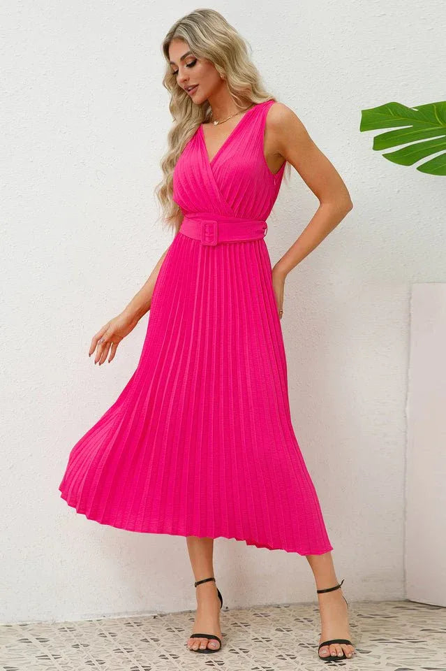 Woman twirling in a bright pink sleeveless pleated midi dress