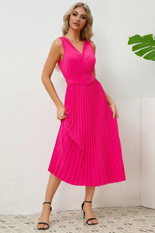 Woman in a pink pleated midi dress, showing the side of the dress Secondary image