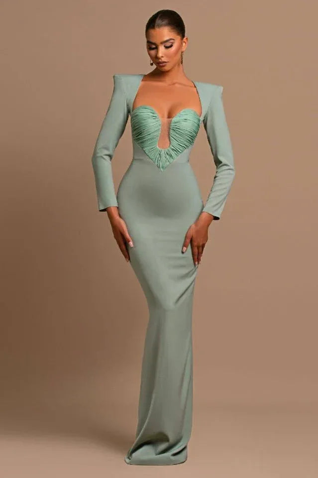 Full-length view of a woman in a sage green formal dress with a fitted silhouette and long sleeves. Secondary image